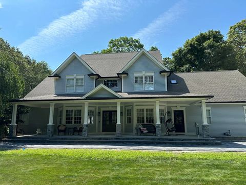 New white seamless gutter installed along a roof edge
