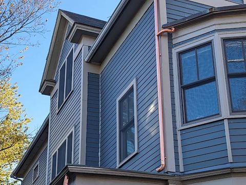 Three-story home with new gutters and downspouts